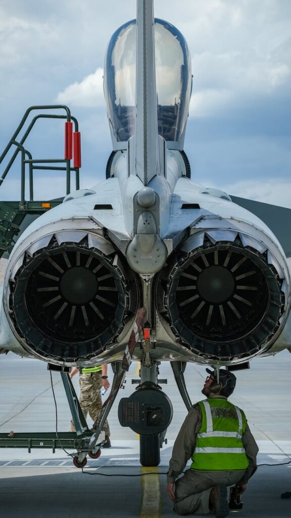 a man sitting under aircraft engine