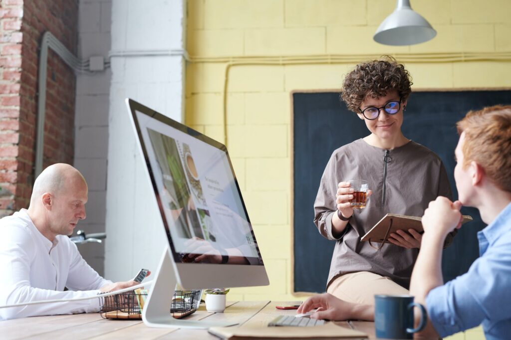 man in blue collared top using imac indoors