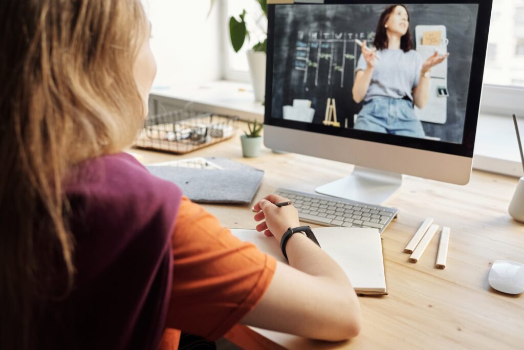 photo of girl watching through imac