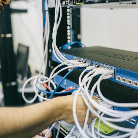 electronics engineer fixing cables on server