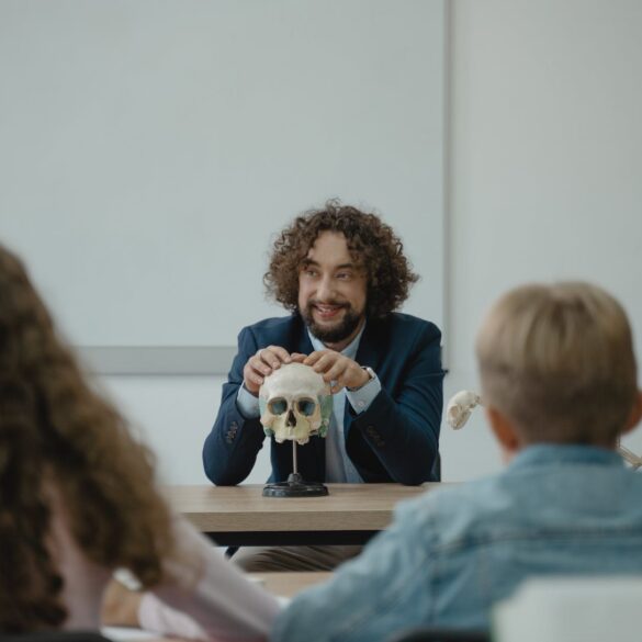 teacher showing his class a human skull