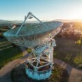 aerial view of large satellite dish at sunset