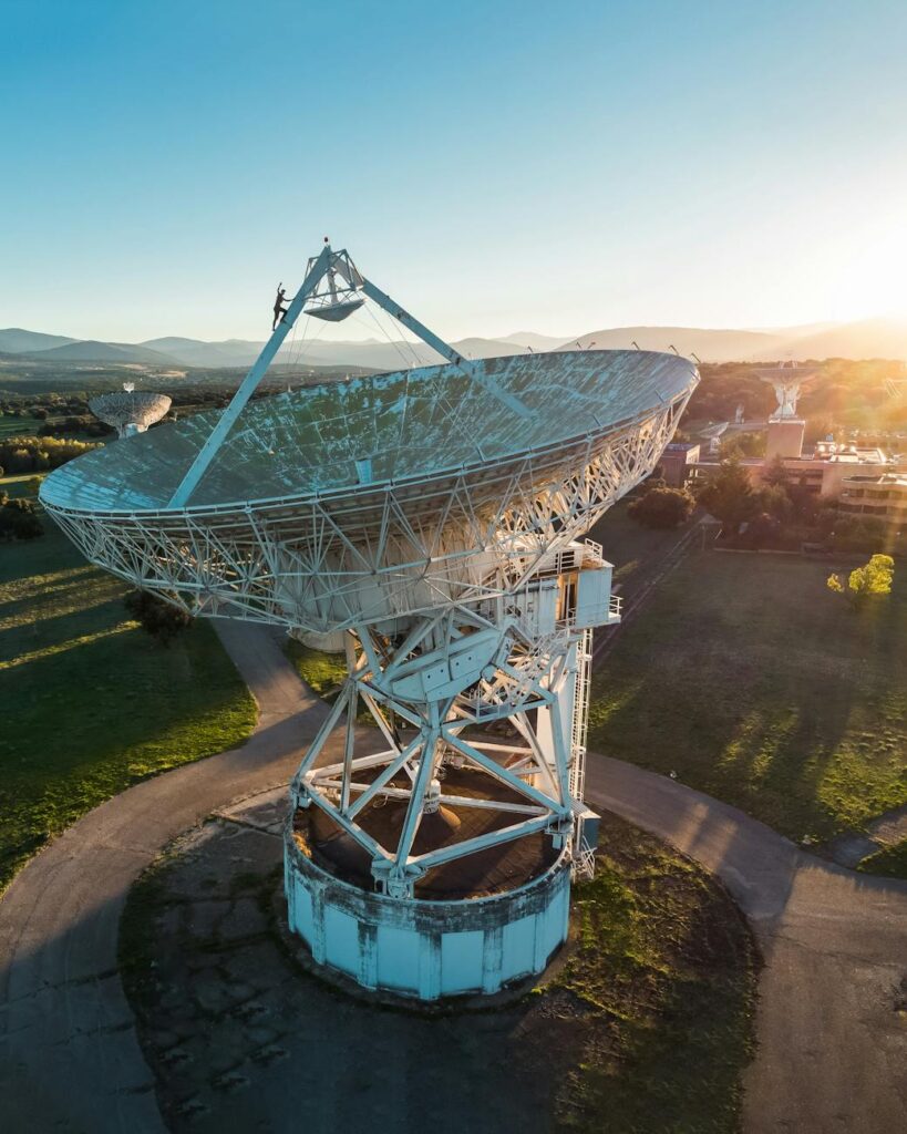 aerial view of large satellite dish at sunset