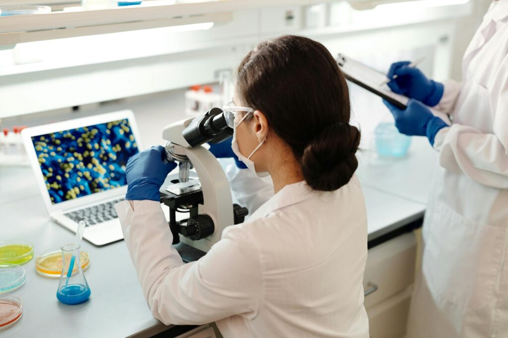 female laboratory scientist looking at a microscope