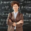 photo of woman standing in front of blackboard